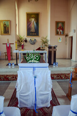 Church sanctuary before a wedding ceremony. Empty chairs for bride and groom.