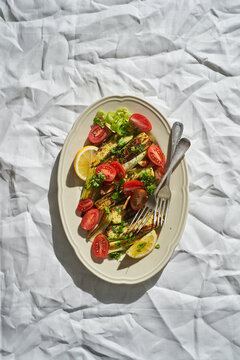 Plate with vegetable salad and forks