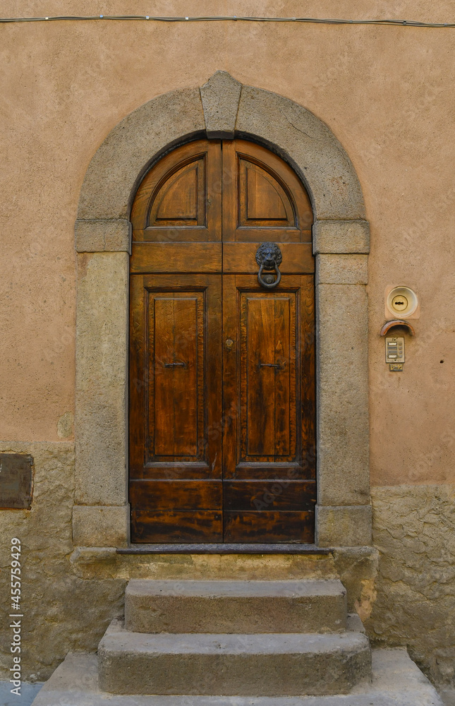 Sticker close-up of the arched door of an old building in the historic centre of castagneto carducci, livorn