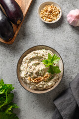 Baba ganoush of baked eggplant with parsley, garlic and olive oil. Vertical format.