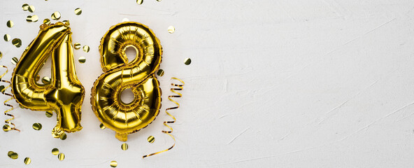 golden foil balloon number forty eight. Birthday or anniversary card with the inscription 48. gray...