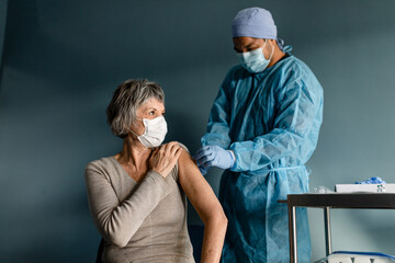 Nurse Puts a Bandage on a Senior Woman's Arm