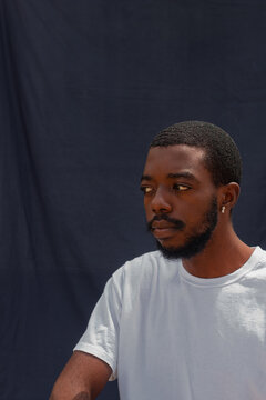 Man sitting in front of a blue backdrop 