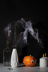 halloween day composition.party greeting card.pumpkin with eyes,candle and dry branch with spider web