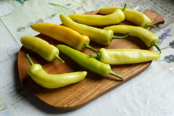 White bitter peppers on a cutting board on the kitchen table