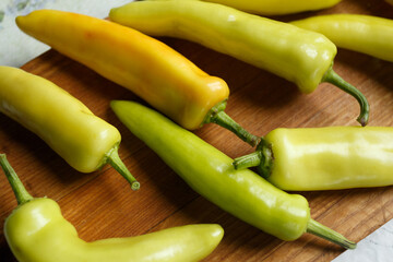 White bitter peppers on a cutting board on the kitchen table