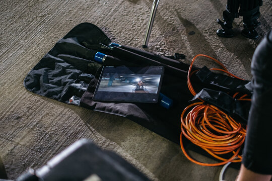 Video and lighting equipment displayed in their cases on concrete floor
