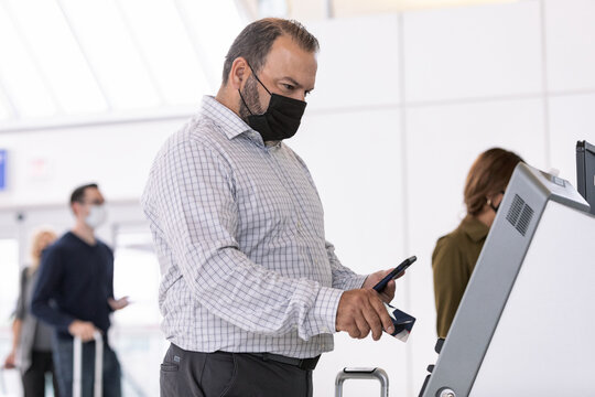 Travel: Male Passenger Uses Self Service Kiosk To Check In