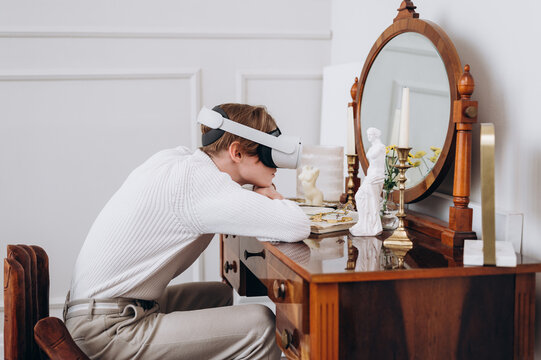 Young man in VR headset sitting at table