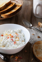 
Homemade cottage cheese with candied fruits on a wooden table