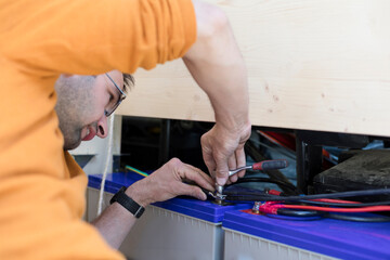Man Working on Accumulator Battery Setup