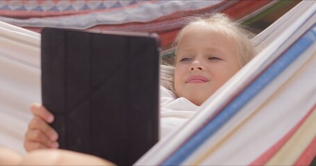 Cute girl in colorful hammock