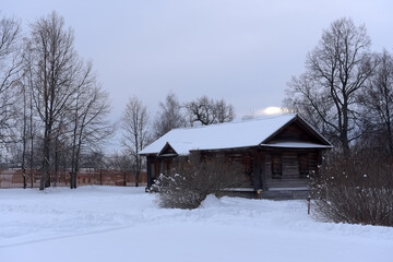 wooden house and trees in the Russian village in winter