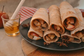 Rolled pancakes with apple cinnamon and honey 
