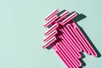 Disposable razors, a creative composition of disposable razors on a turquoise background
