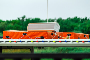 The acoustic column lies on an orange life raft.