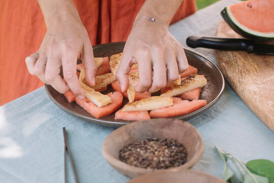 Anonymous Hand Picking Vegan Watermelon Appetizer 