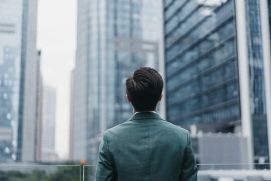 A man standing in front of city buildings 