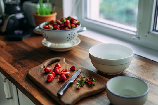 Cutting fresh strawberries for smoothie
