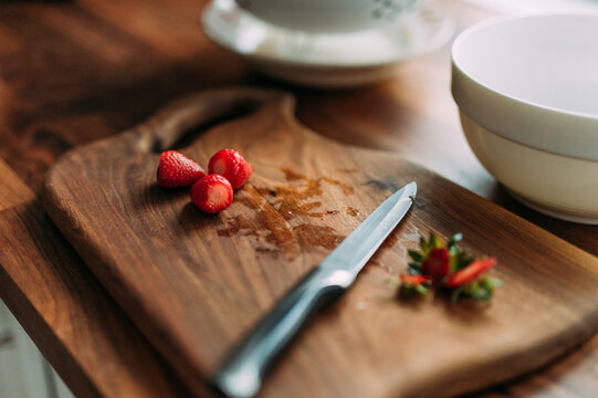 Cutting fresh strawberries for smoothie