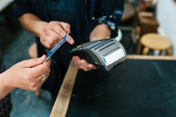 Anonymous hand of a woman paying with credit card