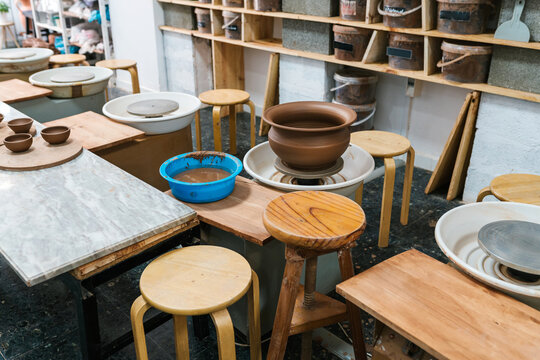 Pottery wheels with vessels in workshop