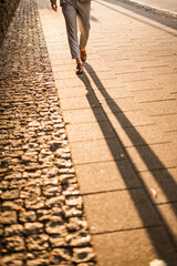 Street in a sunset. Businessman in a suit walking in a sunset.