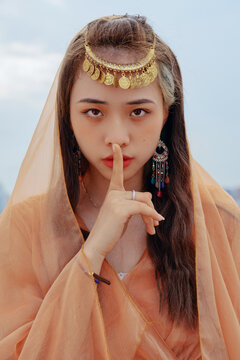 fashion girl making keep quiet gesture