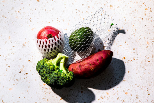 Vegetables in plastic mesh packaging