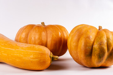 Three whole fresh orange big pumpkin on white background, closeup. Organic agricultural product,...
