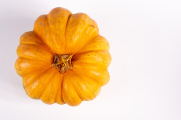 Whole fresh orange big pumpkin on white background, closeup. Organic agricultural product, ingredients for cooking, healthy food vegan.