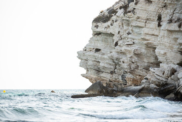blue waves of sea in summer near rock