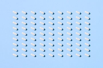 Pill capsule pattern isolated on blue background