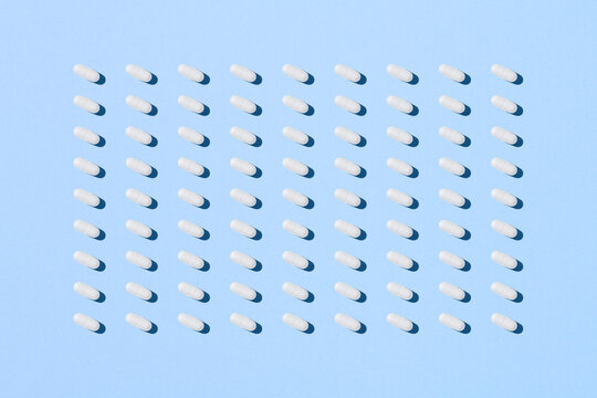 Pill capsule pattern isolated on blue background
