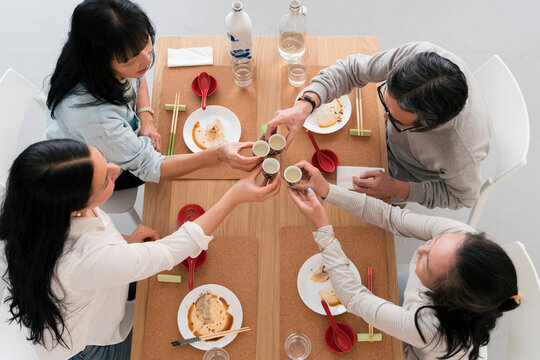 Asian friends drinking sake at home