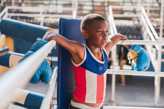 Young boxer in a boxer ring corner.