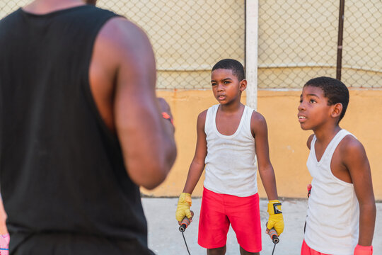 Coach and young boxers in a boxing school.