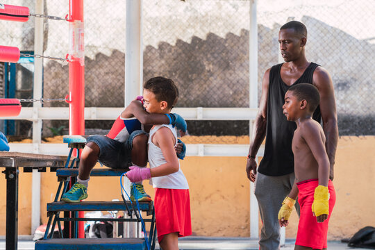 Coach and young boxers near ring