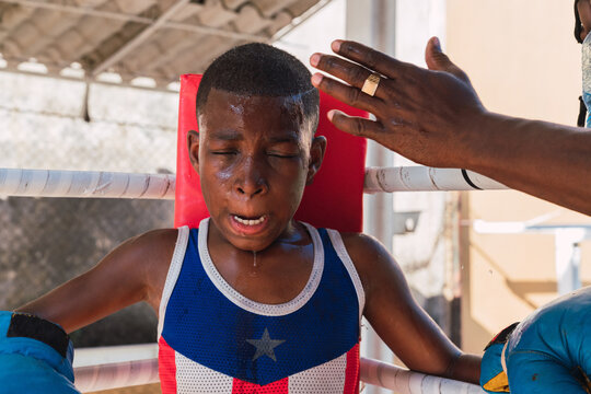 Teen boxer in corner of a ring.
