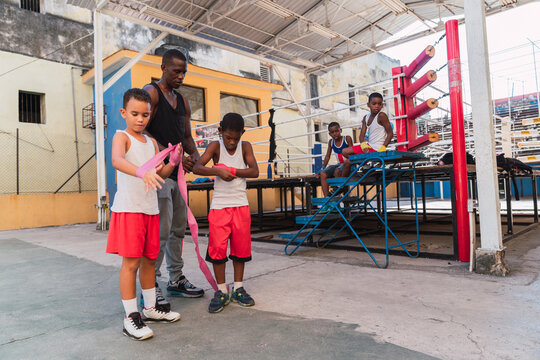 Trainer helping young boxers.