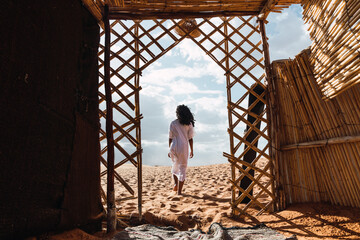 Ethnic woman walking in the desert.