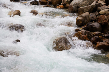 the flow of water in a clear mountain river. Environmental protection.