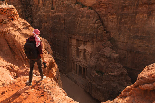 Man standing on top of mountain stone.