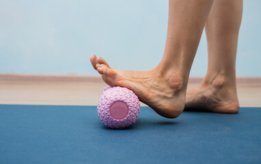 close-up of a woman's leg doing a massage with an orthopedic massager