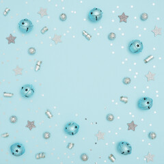 Christmas frame made of various decorations on blue pastel background