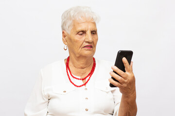 90 years old grandmother talking on the mobile phone, video chat, happy face