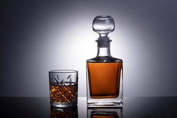 Cognac or brandy glass isolated on gray white background with clipping path. Decander with cognac or brandy