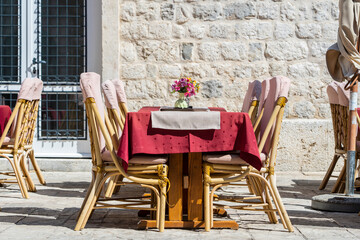 Rattan chairs and table in a street restaurant