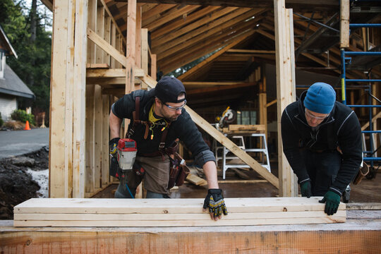 Man working with nail gun doing construction in winter