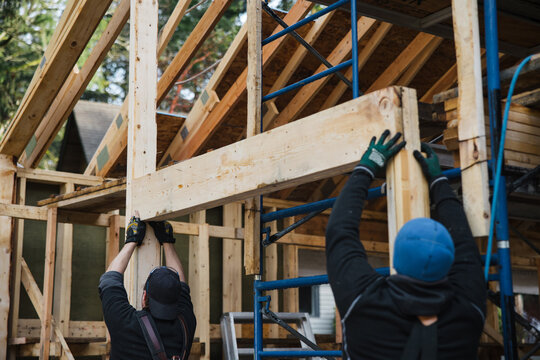 Carpenters building house together in winter